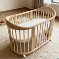 NZMAN Varnished Nursery Furniture Sets Convertible 3-in-1 Newborn Baby Oval Shaped Wooden BPA Free Cot Bed Crib with Wheels